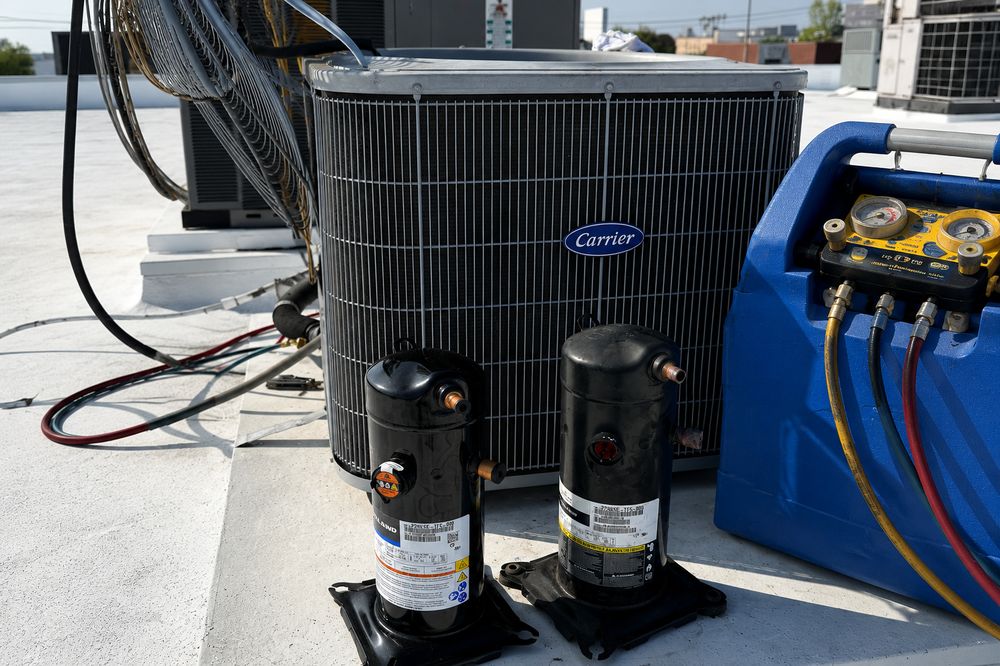 AC condenser with refrigerant recovery equipment during a repair